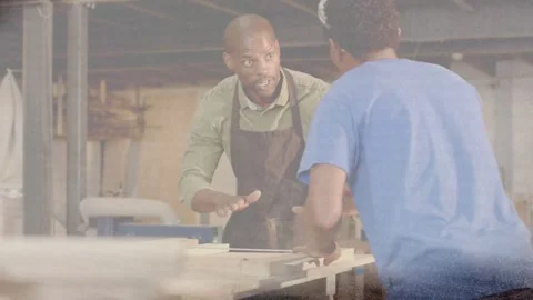 Vertical video: Placing panel, mentor with apron aligning at bench, trainee 動画素材 334114619