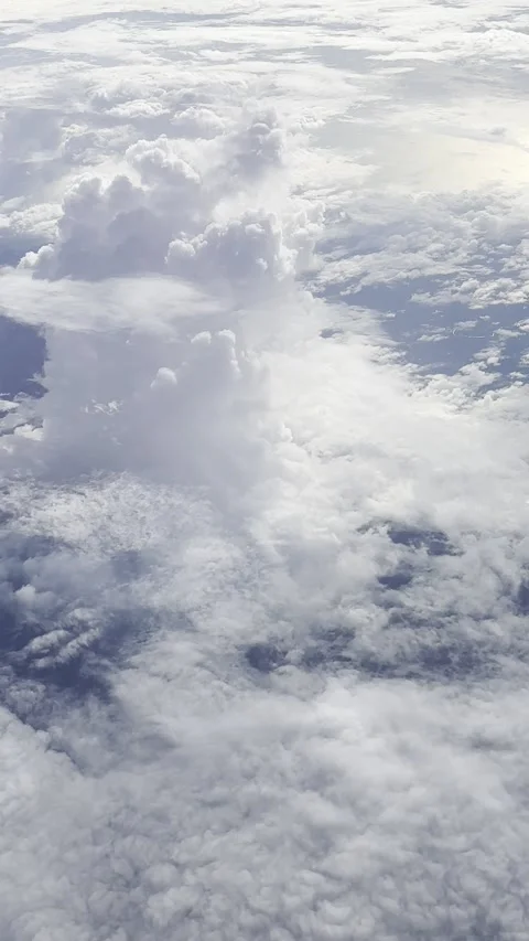 Vertical video from the plane window, beautiful clouds from the plane. Stock Footage 255225409