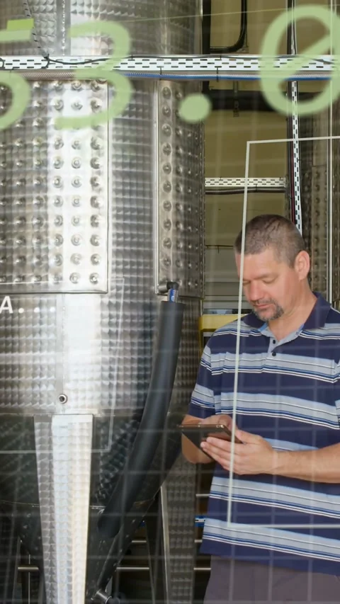 Vertical video: Plant tech tapping tablet at tank, causing green grid over scene Stock Footage 340133427