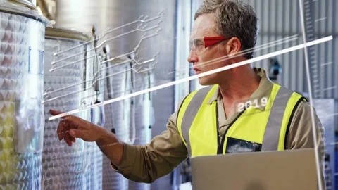 Vertical video: Plant tech touching tank port activating year-data lines while Stock Footage 331871328