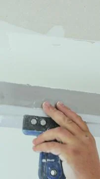 Vertical video Plastering a concrete wall with putty using a large spatula. T Stock Photos