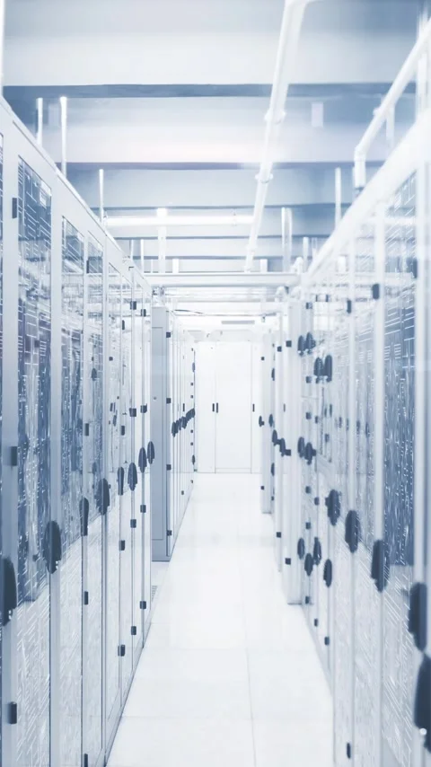 Vertical video: Play starting camera moving down data aisle showing racks Stock Footage 348383295