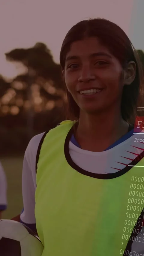 Vertical video: Player holding ball dusk pitch as code overlay rising from right Video stock 330794866