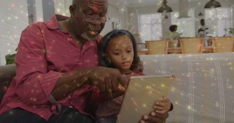 Vertical video: Pointing grandad red top guiding girl with headband tapping Stock Footage 332289444