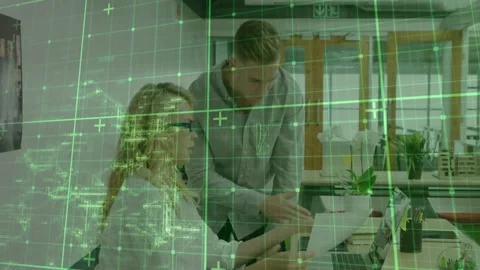 Vertical video: Pointing man nudging woman with specs typing at desk, reviewing Video stock 332405422