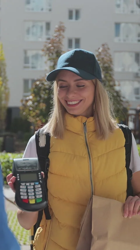 Vertical video. Polite man greets food delivery person with thermal backpack Stock-Footage 344374257