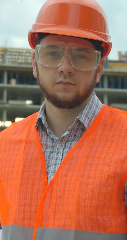 Vertical video. Portrait of an architect or builder in hard hat standing Stock Footage 345502960