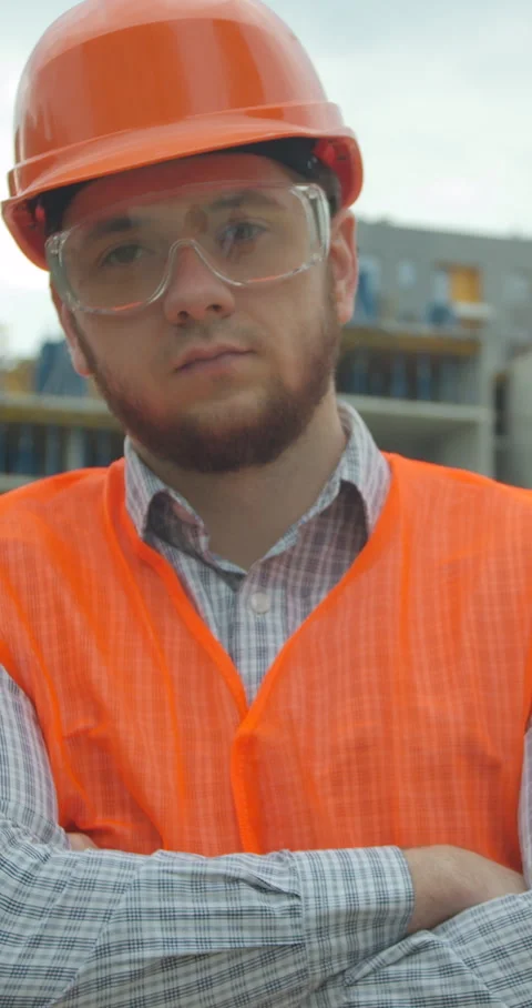 Vertical video. Portrait of an architect or builder in hard hat standing Stock Footage 345503485