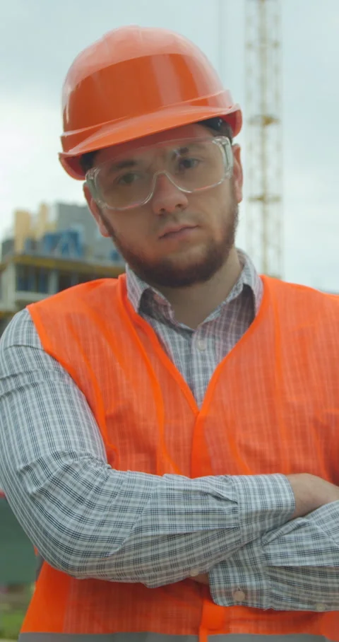 Vertical video. Portrait of an architect or builder in hard hat standing Stock Footage 345503567