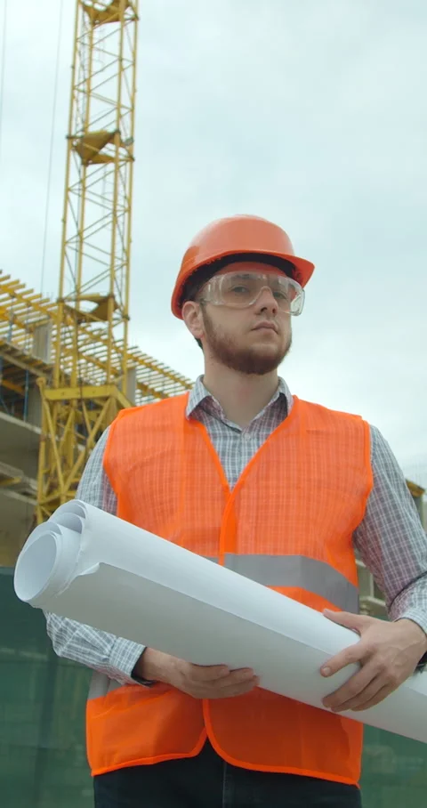 Vertical video. Portrait of an architect or builder in hard hat standing Stock Footage 345504024