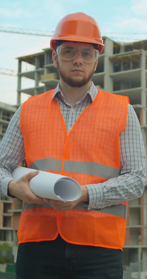 Vertical video. Portrait of an architect or builder in hard hat Stock Footage 345504196