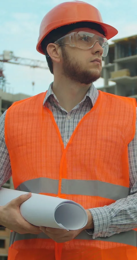 Vertical video. Portrait of an architect or builder in hard hat Stock Footage 345504199