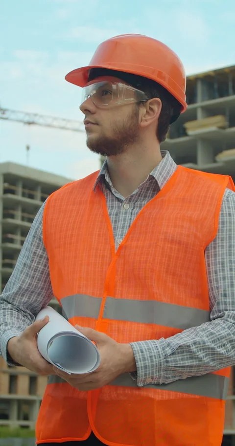Vertical video. Portrait of an architect or builder in hard hat standing Stock Footage 345504221