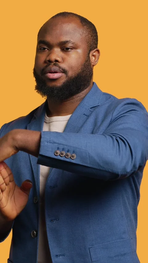 Vertical video Portrait of assertive man asking for timeout, studio background Stock Footage 272709151