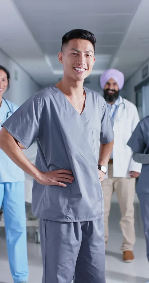 Vertical video of portrait of diverse doctors and nurses looking at camera, in Stock Footage 345128528