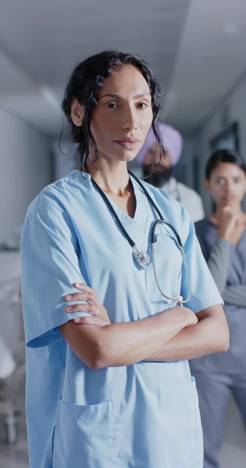Vertical video of portrait of diverse doctors and nurses looking at camera, in Stock Footage 345216772