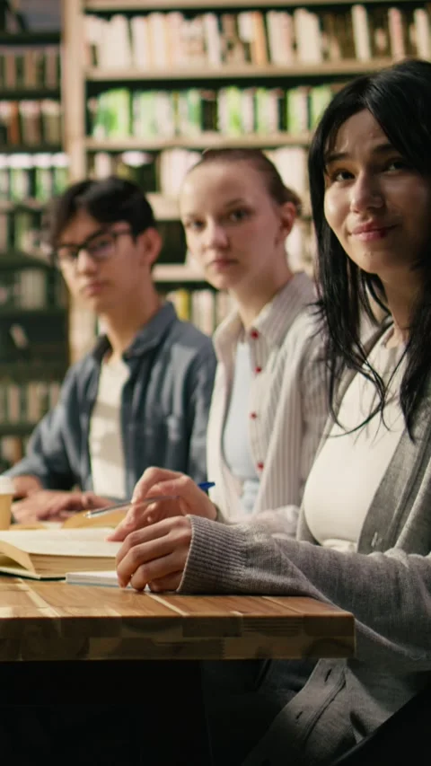 Vertical Video Portrait of diverse students and tutor in group study together at Stock Footage 336378667