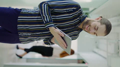 Vertical Video Portrait of the Entrepreneur Using Digital Tablet While Standing. Stock Footage 244205824