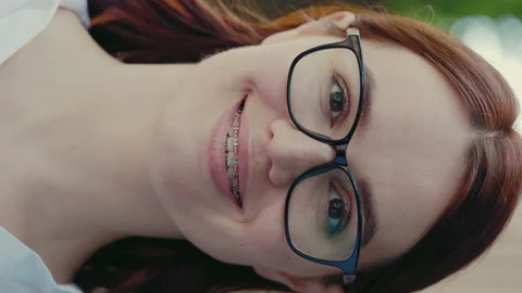 Vertical video portrait of the face of beautiful smiled ginger business woman in Stock Footage 219330100