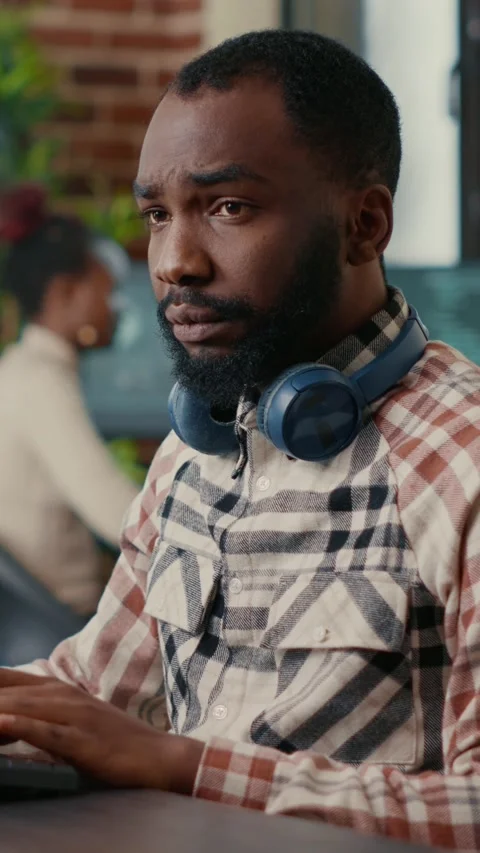 Vertical video Portrait of focused african american programer wearing wireless Stock Footage 201719502