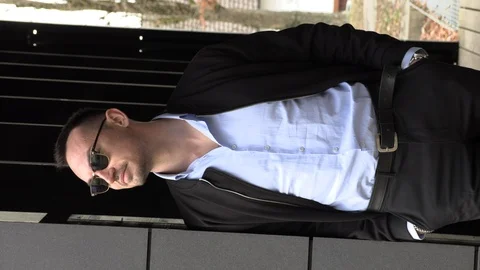 Vertical video, portrait of a handsome smiling man in a black jacket, close-up Stock Footage 126552089
