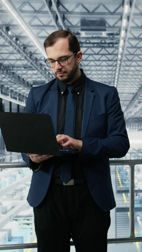 Vertical video Portrait of happy man reviewing microchips plant analytics using Stock Footage 333614014