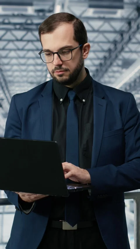 Vertical video Portrait of happy man reviewing microchips plant analytics using Stock Footage 333614385