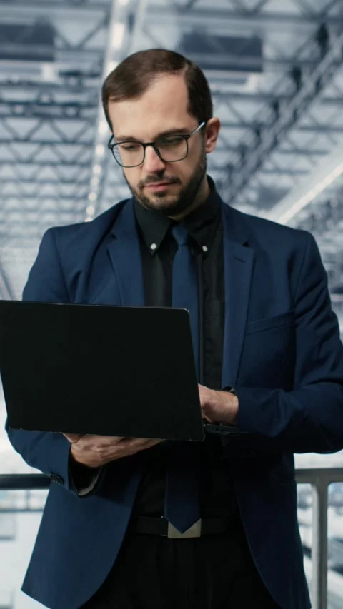 Vertical video Portrait of happy man reviewing microchips plant analytics using Stock Footage 333614423