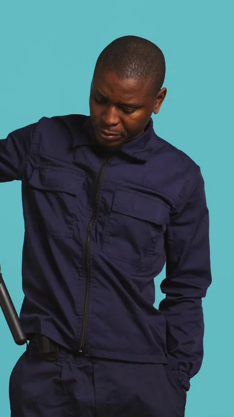 Vertical video Portrait of security agent removing baton from belt to secure Stock Footage 277425364