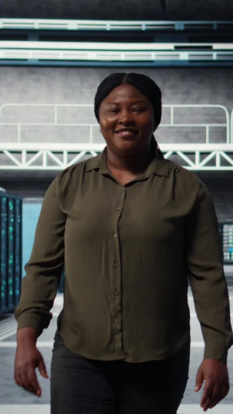 Vertical video Portrait of smiling admin walking in data center, overseeing IT Stock Footage 317054759