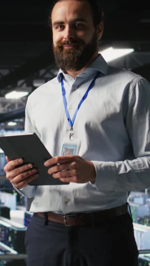 Vertical video Portrait of smiling engineer in data center monitoring AI LLM Video stock 310771426