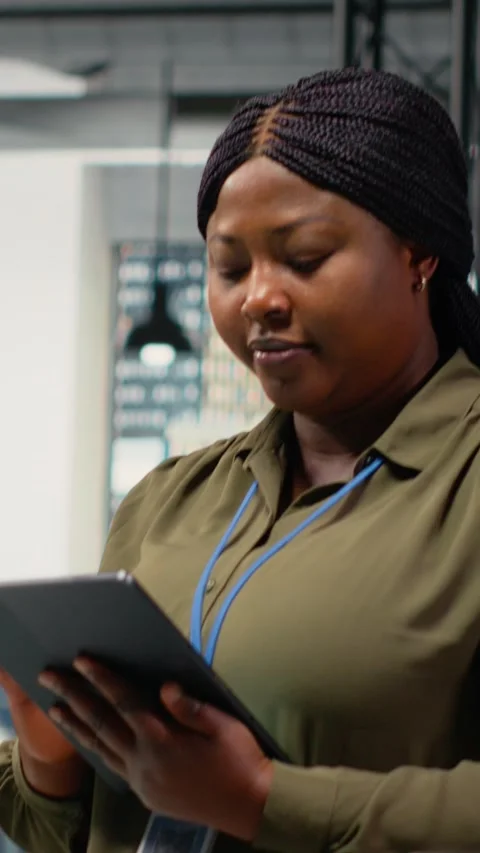 Vertical video Portrait of smiling engineer working in office, using AI Stock Footage 323141980