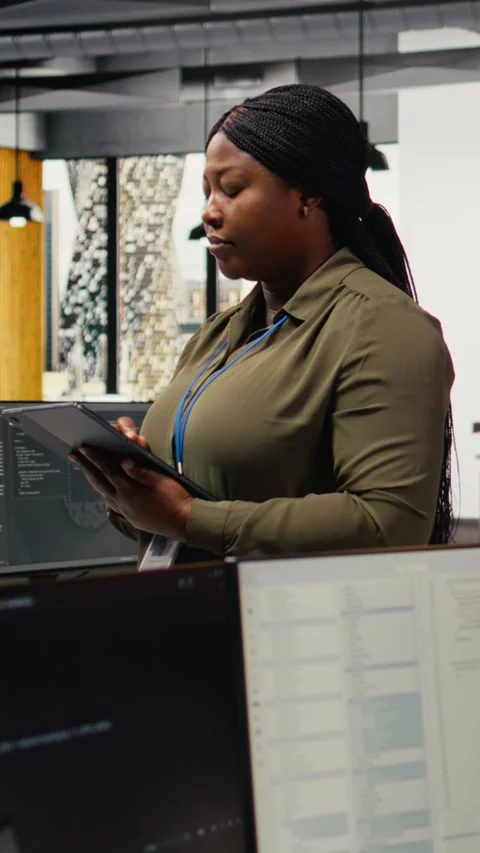 Vertical video Portrait of smiling engineer working in office, using AI Stock Footage 323329889