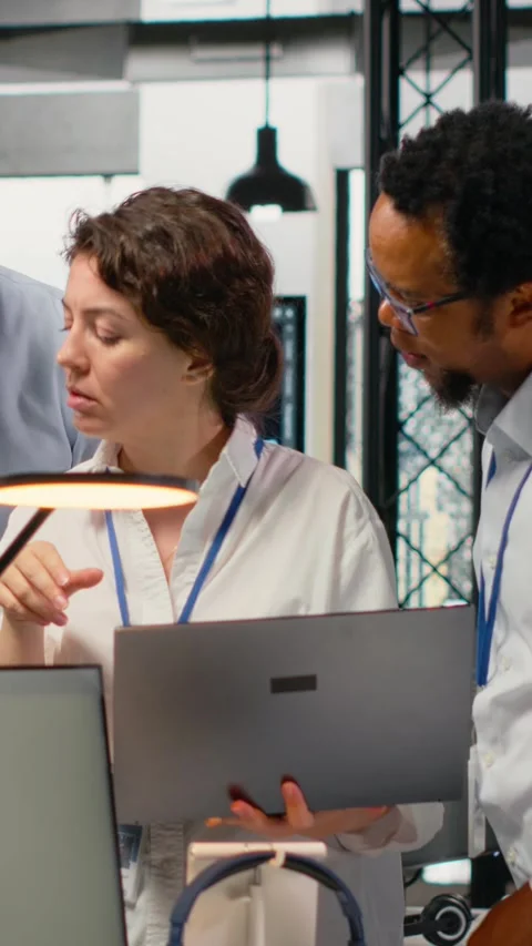 Vertical video Portrait of smiling engineering team in office automating Stock Footage 323142053