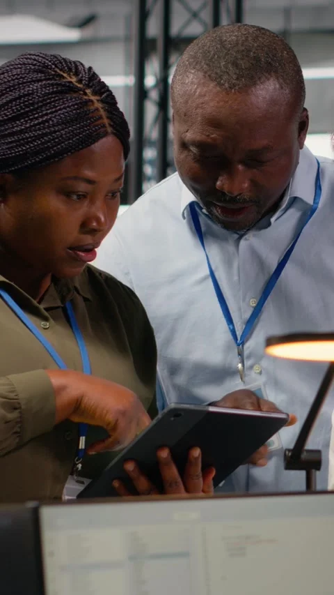 Vertical video Portrait of smiling engineering team in office doing software Stock Footage 323403395