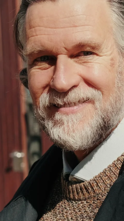 Vertical video, Portrait of a Smiling Senior Man Outdoors Stock Footage 310444235