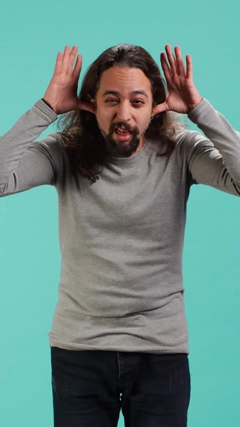 Vertical video Portrait of spiteful man making exaggerated silly faces Stock Footage 314516293
