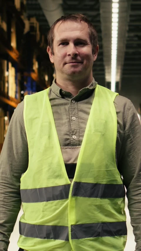 Vertical Video Portrait of warehouse worker in a modern logistics distribution Stock Footage 332914201