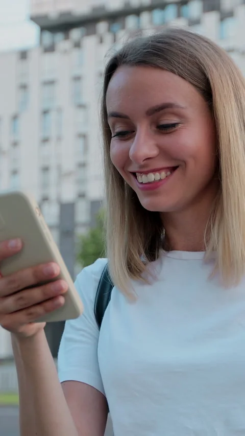 Vertical video. Portrait of woman is using smartphone after ride Stock-Footage 344431025