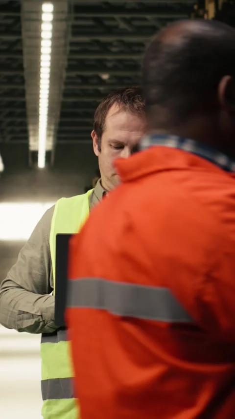 Vertical Video Portrait of worker checking shipment labels in modern warehouse Stock Footage 333089649