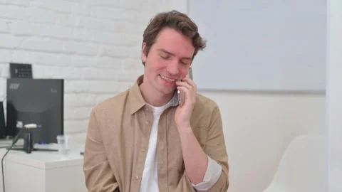 Vertical Video, Portrait, Young Creative Man Talking on phone Stock Footage 312914615