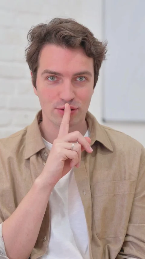 Vertical Video, Portrait, Young Creative Man Showing Silence Gesture Stock Footage 318049404