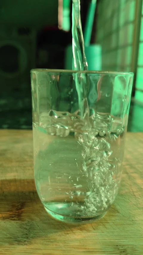 Vertical Video Pouring Clear Drinking Water into Glass Hydration. Stock Footage 330116568