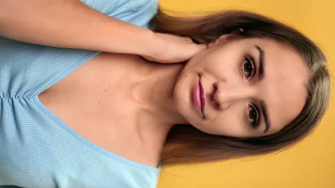 VERTICAL VIDEO POV closeup face of tired young woman feeling head neck pain Stock Footage 164984067