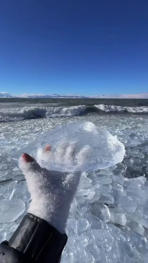 Vertical video POV shot of hand in white glove holding a crystal clear ice b Video stock 327691674