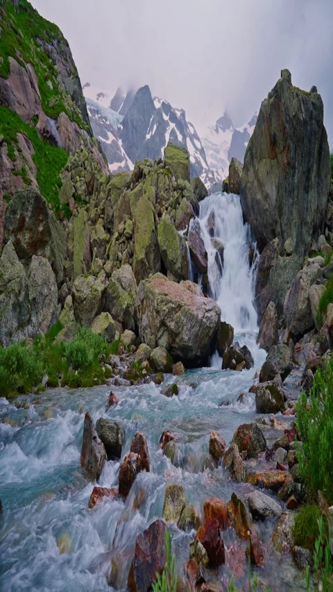 Vertical video. Powerful stream of clean water quickly flows along mountain Stock Footage 293137795