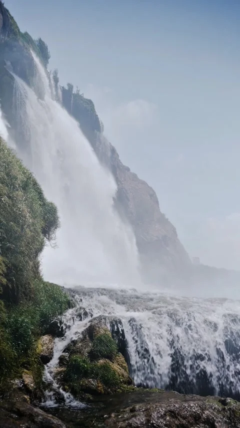 Vertical Video of Powerful Waterfall Plunging Down a Rocky Cliff Stock-Footage 337680576