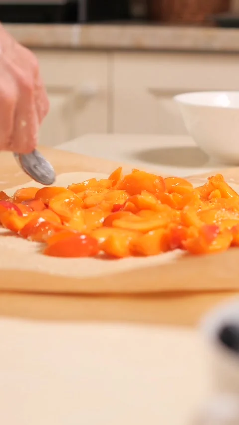 Vertical video Preparing a fruit galette in a home kitchen, step-by-step process Stock Footage 283138163