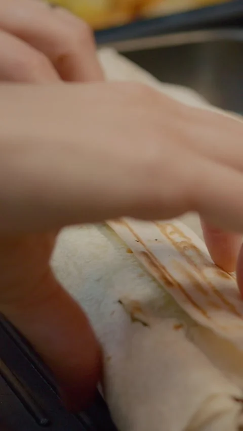 Vertical video Preparing lavash kebabs on a grill pan for a delicious meal Stock Footage 329626162