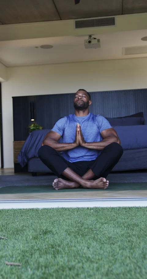 Vertical video: Pressing palms, man meditating, breathing for calm at home on Stock Footage 345040815
